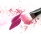 Purple and pink make up powder, lipstick smear with brush.