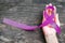 Purple plum ribbon on helping hand support for raising awareness on Alzheimer`s disease, family caregivers, epilepsy