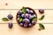 Purple plums in bowl. Plum harvest top view