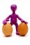 Purple puppet of plasticine holding two eggs