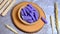 Purple raspberry wafer roll stick on a wooden bowl. Food Photography