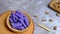 Purple raspberry wafer on a wooden bowl. Food Photography