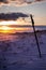 Purple, Red, and Orange, and Blue Beach Landscape Portrait with Metal Stake in Sand