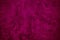 Purple red vintage background. Painted wall background with space for design. Toned dark magenta rough surface.