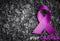 Purple ribbon awareness on dark background with STOP CANCER word