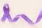 Purple ribbon bow on white fabric with copy space. Hodgkin Lymphoma Awareness, Testicular Cancer, Alzheimer disease, Epilepsy
