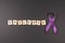 Purple ribbon and EPILEPSY word on black background.