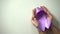 Purple ribbon in lady hands, world Alzheimer disease awareness day, healthcare