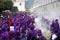 Purple robed men use incense smoker in front of float at the procession San Bartolome de Becerra, Antigua, Guatemala