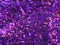 Purple sequined fabric texture - pink and purple sparkling sequins background. Festive, carnival or fashion background concept.