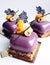 Purple shiny glazed dessert with hazelnut and coral lace crepe decor