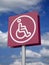 PURPLE SIGN OF DISABLED PERSON AGAINST BLUE SKY AND CLOUDS