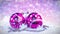 Purple and silver christmas balls on snow with glitter bokeh background. Seamless loop. 3D render