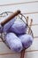 Purple skeins of cotton yarn in a basket