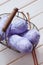 Purple skeins of cotton yarn in a basket