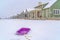 Purple sled against snow and homes in Daybreak