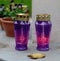 Purple small religious candleholders with lit candles