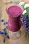 Purple smoothie with blue and white flower