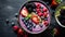 Purple smoothie bowl topped with nuts and berries