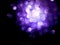 Purple sparkles on black background. Abstract image of sparkles