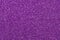 Purple sparkly fabric texture, Christmas paper backgrounds. Dark violet glitter surface. Abstract grain pattern. Festive