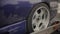 Purple sports car is loaded on a carrier trailer. Rear wheel close-up.