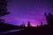 Purple Stary Night Sky Over Forest and Lake