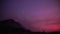 Purple sunset on the background of smog from forest fires in the mountains