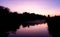 Purple sunset hovers over river