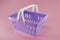 Purple supermarke basket or grocery Bucket with two white handles. Realistic shopping carts isolated on pink background. Empty