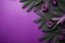 Purple table with Christmas tree branches and cones, a place for text