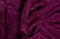 Purple terry background in a fold close up
