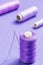 Purple thread bobbin and needle.Useful as tailor background