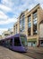 Purple tram in front of art deco building taken in Reims