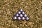 Purple triangle on pebblestone background