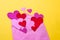 Purple Valentine envelope with colorful hearts on yellow background