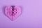 Purple Valentine origami on a lilac background. Heart of paper. Surprise on Valentine`s Day.