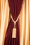 Purple velvet curtain with golden tassel