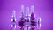 Purple, violet, lilac stylish golden background with bottles of nail polish. Fashion, makeup, manicure, beauty