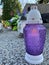 Purple and white candle, lamp on the grave, lights placed in the cemetery, flowers and candles at the burial place, yellow chrysan