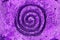 Purple wind vortex spiral ornament on the wall texture