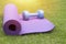 Purple yoga mat and blue dumbbell