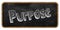 PURPOSE written in chalk on blackboard. Wood frame.