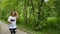 Purposeful woman runs in the park. Persistent motivation