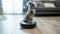 Purr-fect Harmony: Kitten Rides Robot Vacuum in Modern Living Room