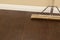 Push Broom on a Newly Installed Laminate Floor and Baseboard