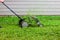 Push lawnmower in action with grass flying around/ Lawncare concept