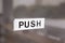 PUSH sign on glass door