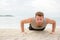 Push-ups crossfit man fitness training on beach