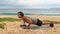 Push ups - fitness man exercising outside doing pushups using dumbbells